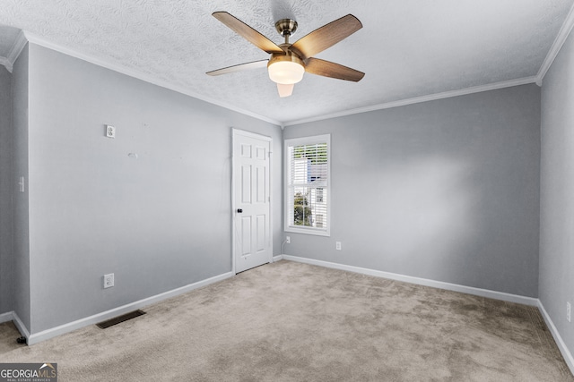 carpeted empty room with a textured ceiling, crown molding, and ceiling fan