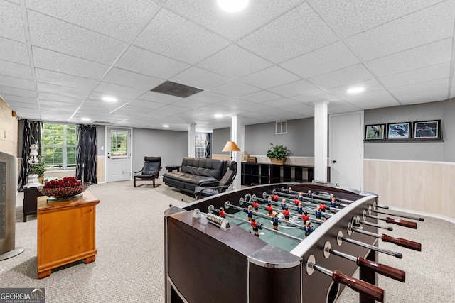 game room with wood walls, a paneled ceiling, and carpet floors