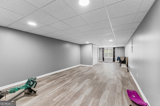 basement featuring hardwood / wood-style floors and a drop ceiling