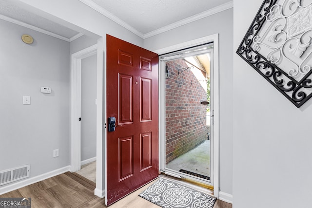 entryway featuring ornamental molding and hardwood / wood-style flooring