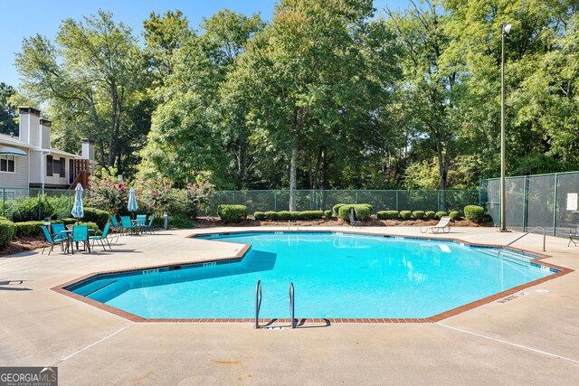 view of swimming pool featuring a patio area