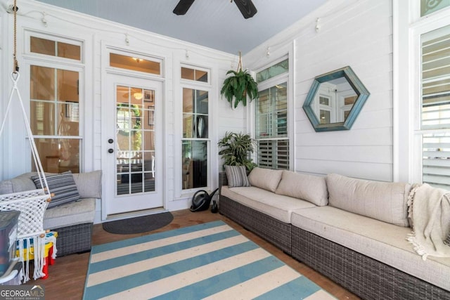 sunroom featuring ceiling fan