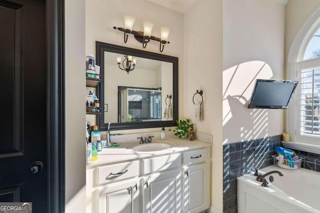 bathroom featuring vanity and a washtub