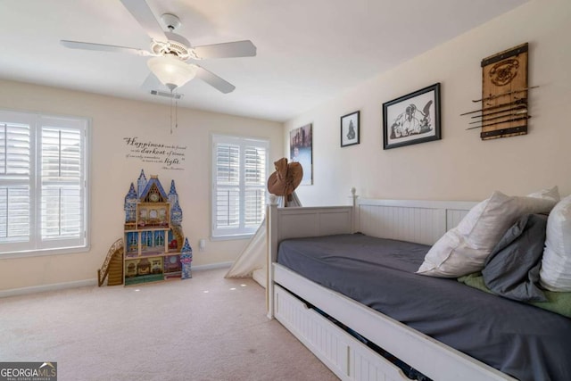 bedroom featuring ceiling fan and light carpet