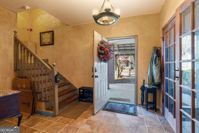 foyer entrance featuring plenty of natural light and an inviting chandelier