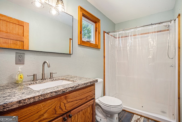 bathroom with vanity, toilet, a shower with curtain, and hardwood / wood-style flooring