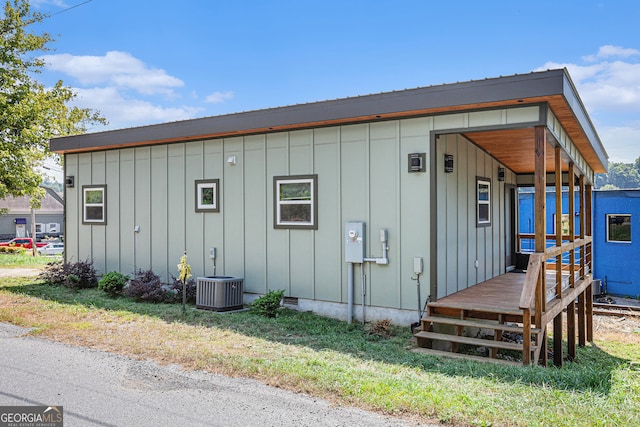 exterior space featuring a yard and central AC