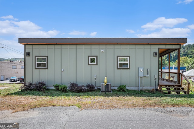 view of side of home with central AC