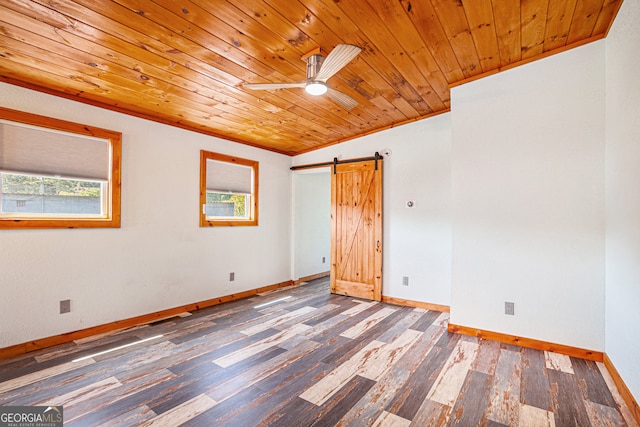 spare room with vaulted ceiling, wood-type flooring, ceiling fan, wood ceiling, and a barn door