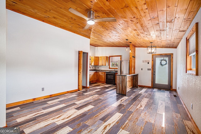 kitchen featuring ceiling fan with notable chandelier, dark hardwood / wood-style flooring, pendant lighting, wood ceiling, and stainless steel refrigerator