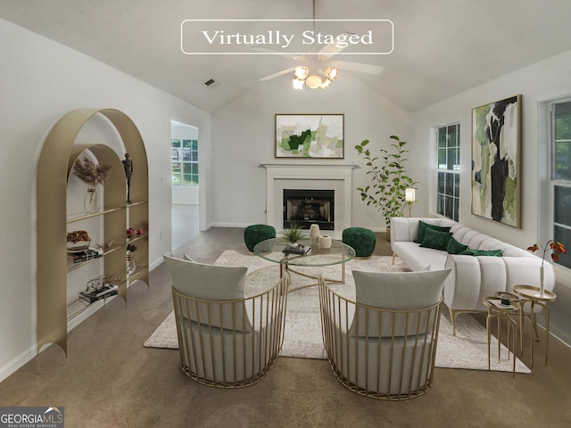 living area featuring ceiling fan, a fireplace, carpet flooring, visible vents, and vaulted ceiling