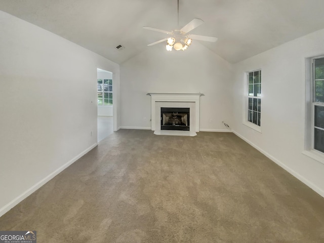 unfurnished living room with baseboards, visible vents, lofted ceiling, carpet flooring, and a fireplace