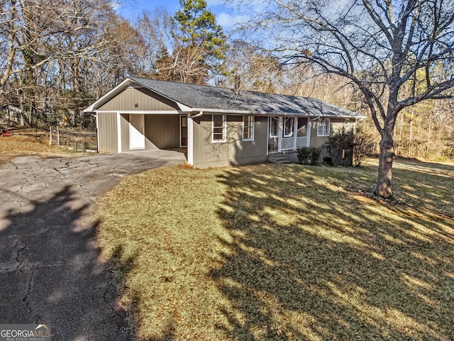 ranch-style house with a front lawn and a carport