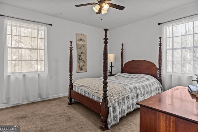 carpeted bedroom with ceiling fan and multiple windows