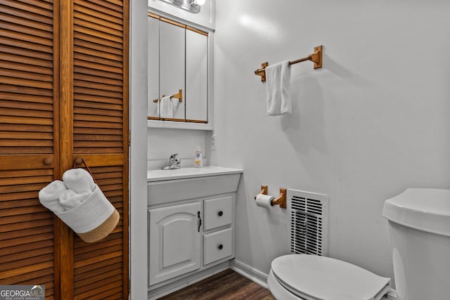 bathroom with vanity, hardwood / wood-style floors, and toilet