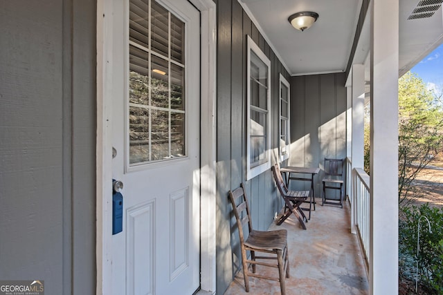 view of exterior entry with covered porch