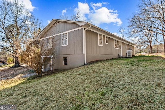 view of property exterior featuring a lawn and central air condition unit