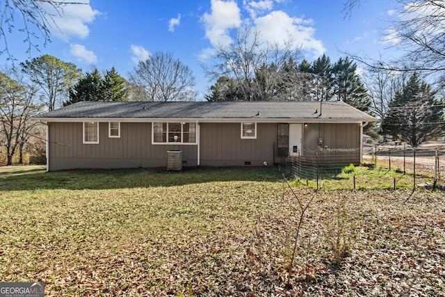 back of property featuring central AC and a lawn