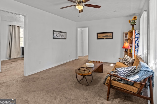 living room with light colored carpet, a textured ceiling, and ceiling fan