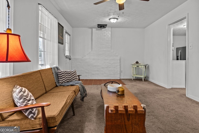 living room with ceiling fan, carpet floors, and a textured ceiling