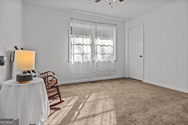 sitting room with carpet flooring and ceiling fan