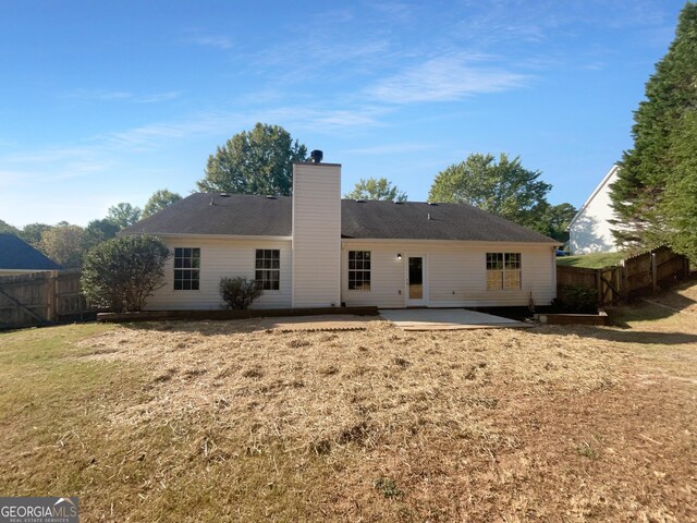 rear view of property featuring a patio area and a yard