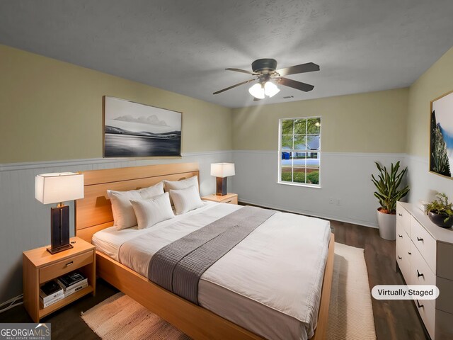 bedroom featuring wood-type flooring, a textured ceiling, and ceiling fan