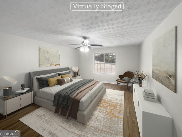 bedroom with a ceiling fan, a textured ceiling, and wood finished floors