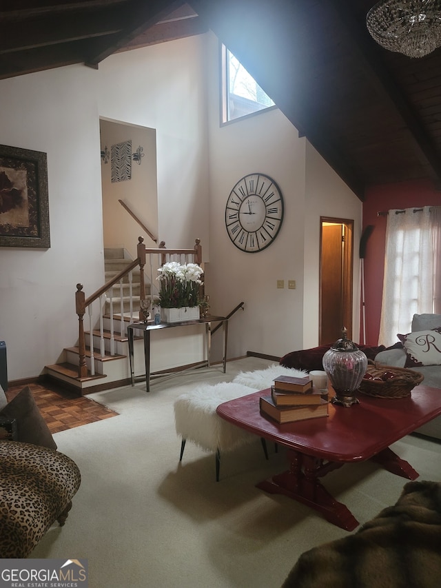 carpeted living room with plenty of natural light and vaulted ceiling with beams