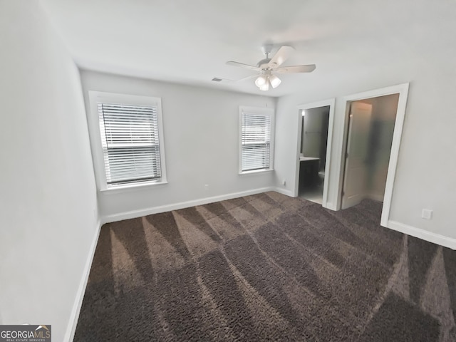 unfurnished bedroom featuring ceiling fan, carpet, ensuite bath, and baseboards