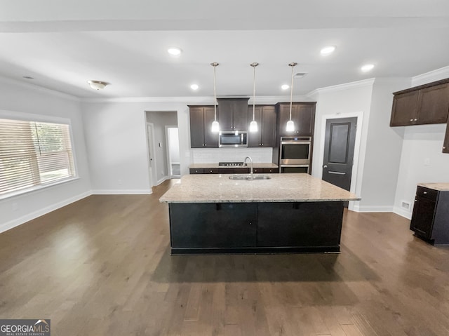 kitchen featuring dark wood-style flooring, a sink, appliances with stainless steel finishes, backsplash, and crown molding