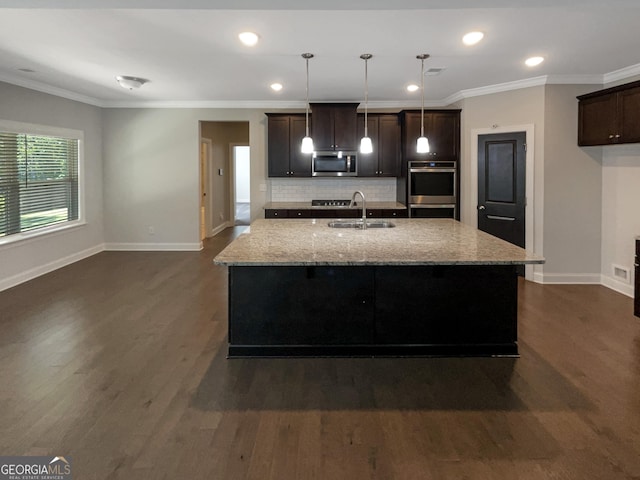 kitchen featuring appliances with stainless steel finishes, ornamental molding, dark wood-style flooring, light stone countertops, and a sink