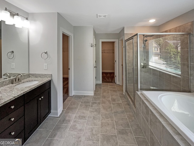 full bath featuring tile patterned flooring, a garden tub, a shower stall, and vanity