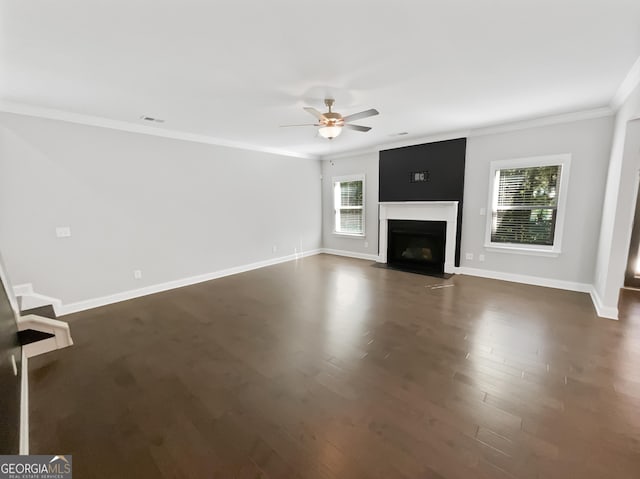 unfurnished living room featuring ornamental molding, baseboards, a fireplace with flush hearth, and dark wood-style floors