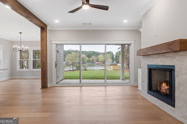 unfurnished living room featuring light hardwood / wood-style flooring, beamed ceiling, ceiling fan with notable chandelier, and ornamental molding