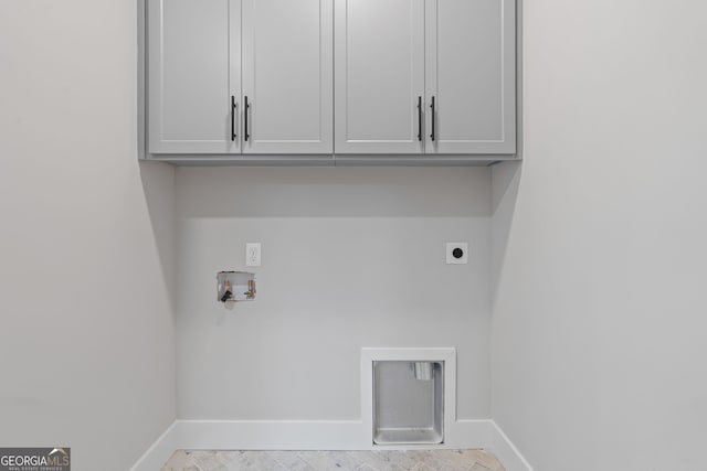 laundry area with hookup for an electric dryer, cabinets, and hookup for a washing machine