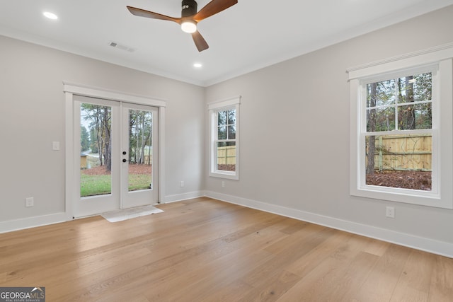 unfurnished room featuring french doors, a healthy amount of sunlight, and light wood-type flooring