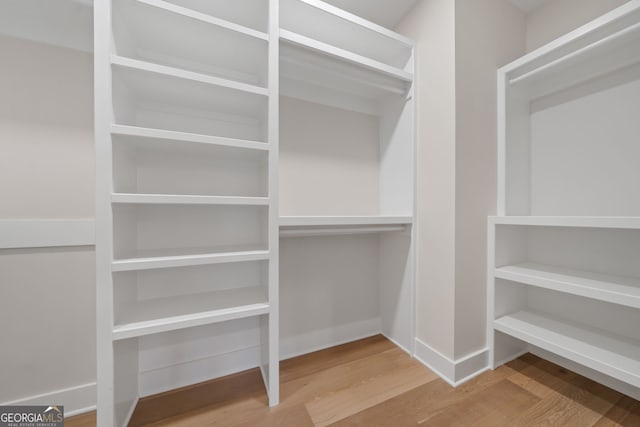 walk in closet featuring hardwood / wood-style flooring