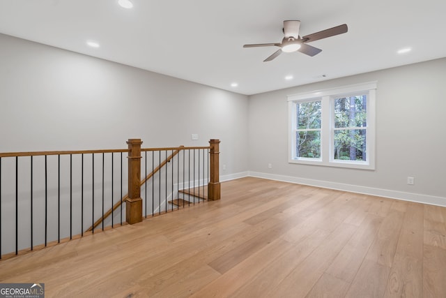 spare room with ceiling fan and light wood-type flooring