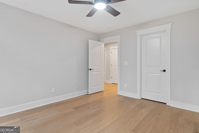 unfurnished bedroom featuring ceiling fan and light wood-type flooring