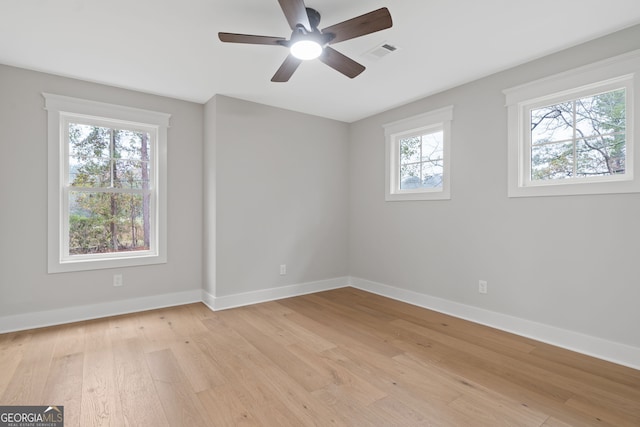 unfurnished room with ceiling fan and light wood-type flooring