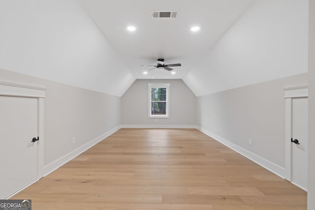 additional living space with ceiling fan, vaulted ceiling, and light wood-type flooring