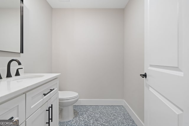 bathroom with tile patterned flooring, vanity, and toilet