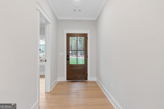 doorway to outside with light hardwood / wood-style floors and crown molding