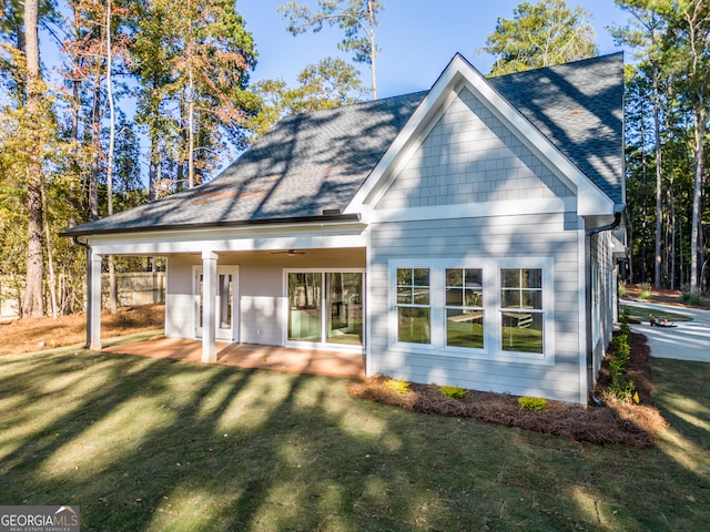 back of house with a lawn