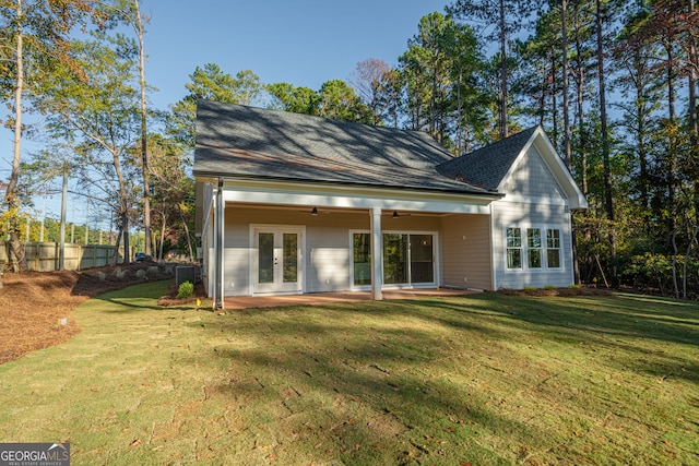 back of property featuring a yard, central AC, ceiling fan, and french doors