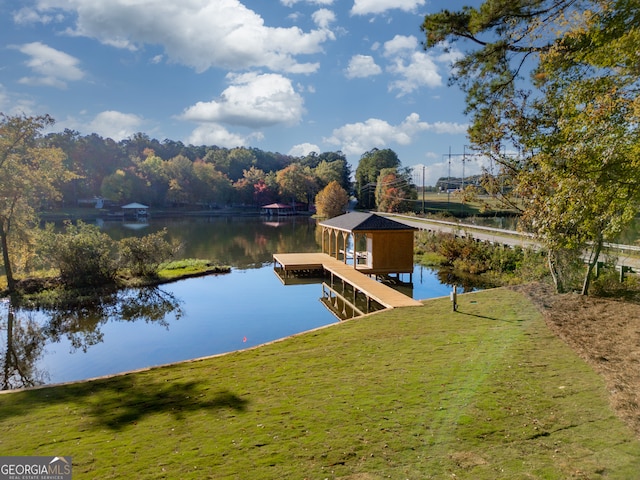 dock area featuring a yard and a water view