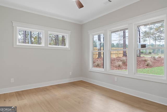 unfurnished room featuring ceiling fan, ornamental molding, and light hardwood / wood-style flooring