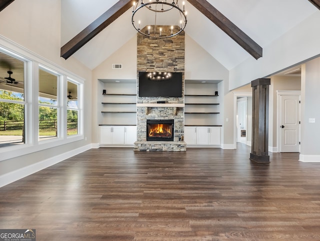 unfurnished living room featuring dark hardwood / wood-style floors, beamed ceiling, high vaulted ceiling, and a stone fireplace