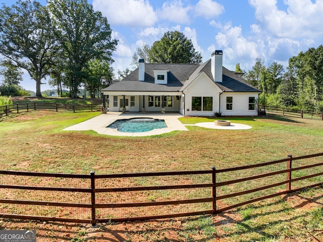 rear view of property featuring a yard and a patio area